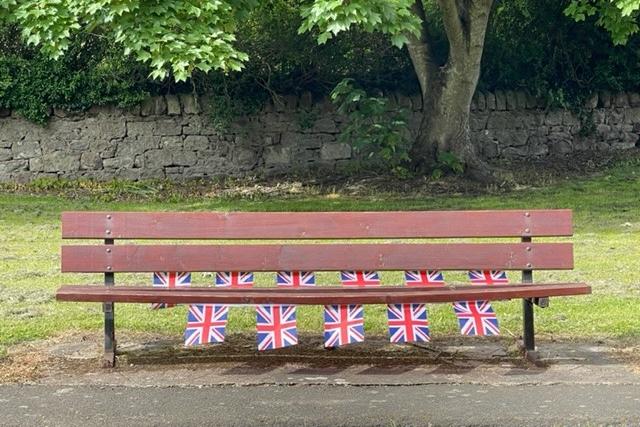 Bunting brightening up a public bench.