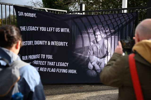 A banner placed by fans is fixed to the railings outside Old Trafford stadium ahead of the funeral.  (Photo by Oli SCARFF / AFP) (Photo by OLI SCARFF/AFP via Getty Images)