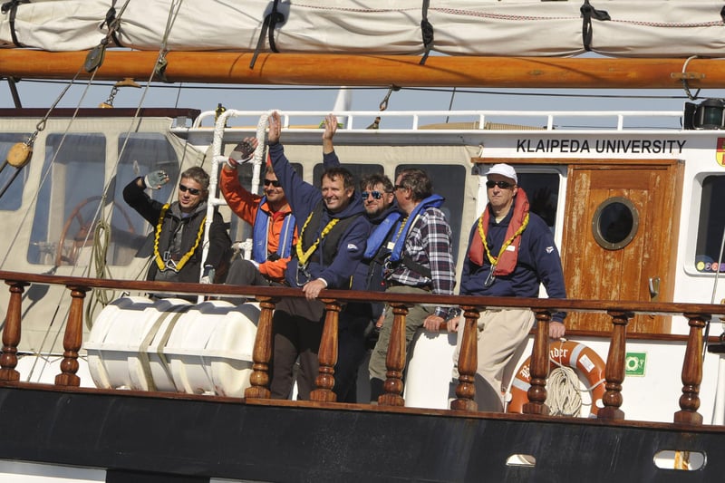 Crew members wave to the crowds.