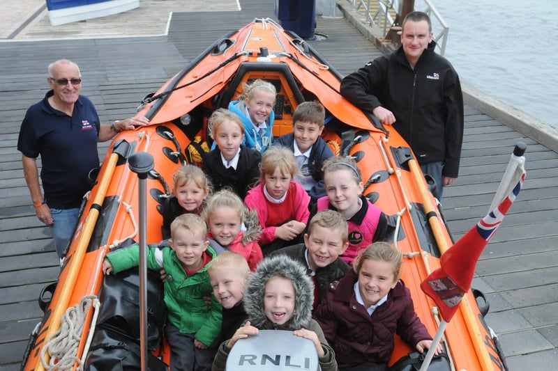 Pupils from Newsham Primary School visiting Blyth RNLI station in 2013 after designing art work for around the station. They are with Steven Fitch, crewman, and Dave Brown, education officer.