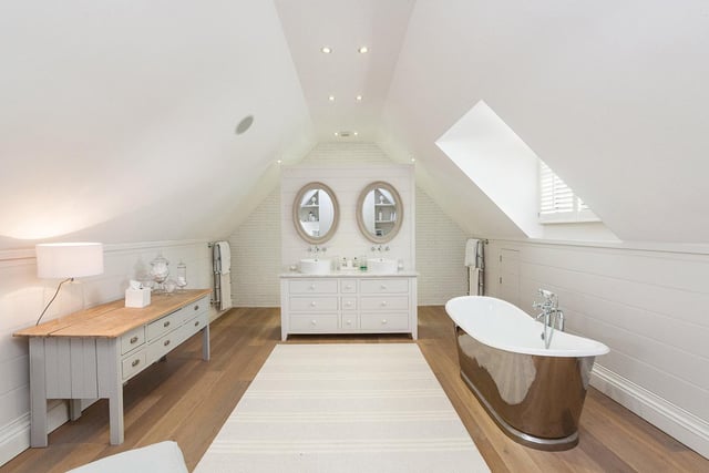 The beautifully appointed en-suite bathroom from the principal bedroom has a contemporary freestanding roll top bath, heated towel rails and WC.