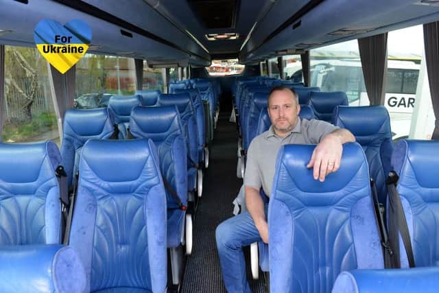 Gardiners Holidays managing director Adrian Smith on board one of the coaches which will be used to relocate refugee families fleeing from Ukraine.