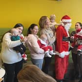 New mums brought their newborns along to the Christmas party to meet Santa. (Photo by Bright)