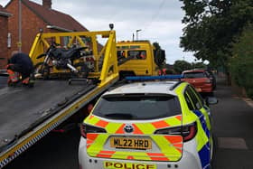 A motorbike being taken away by Police after a series of raids  Bedlington.