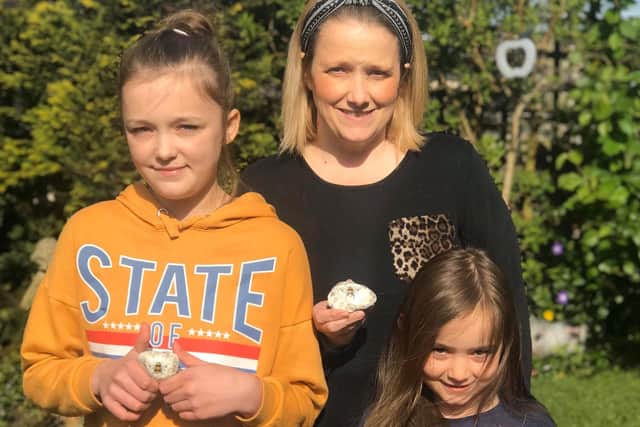 Susannah Scott with her daughters, Alice and Madelyn, who have been painting stones for the Wooler community.