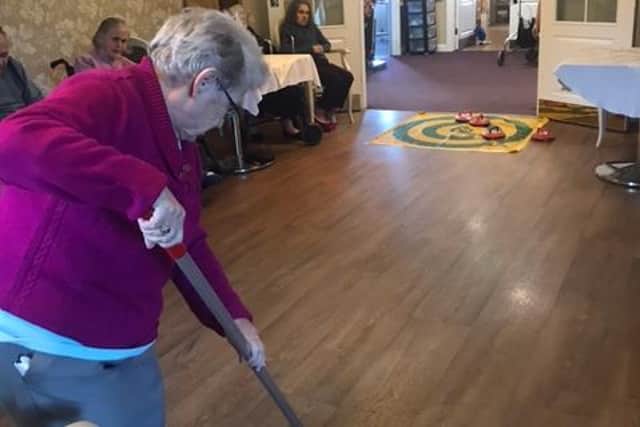 A resident at Woodhorn Park care home has a go at 'New Age Curling'.