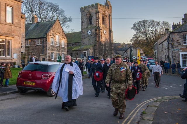 The parade makes its way from the church to the war memorial.