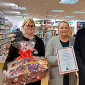Councillor Bob Walkinshaw presenting the staff at the Salvation Army shop with their certificate and prize.