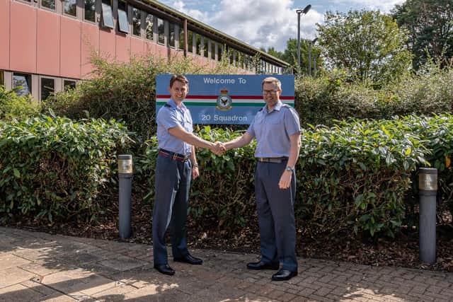 Wing Commander Andy Foy hands over the pennant to Wing Commander Rob Machin.