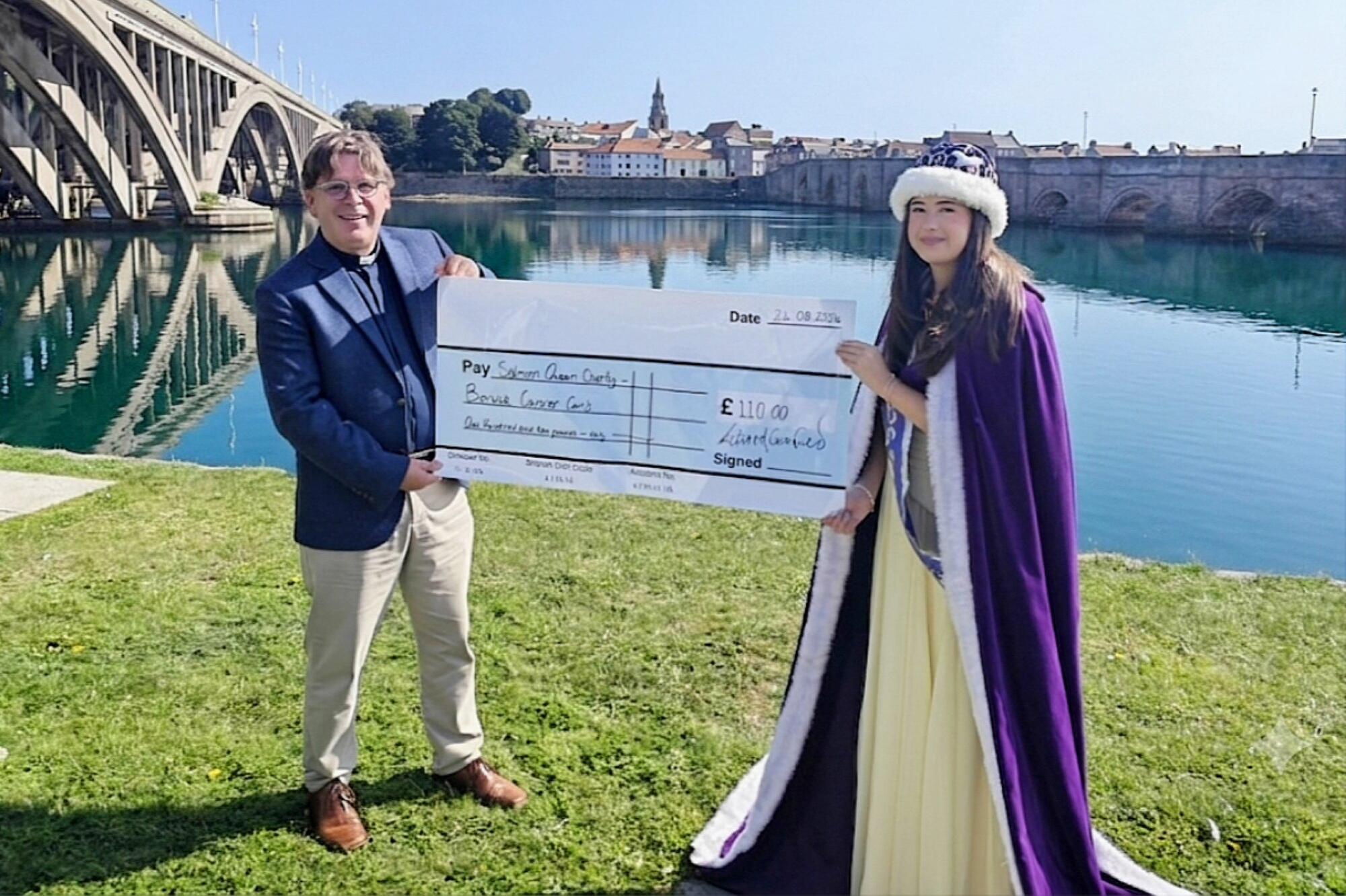 Vicar presents cheque to Tweedmouth Salmon Queen in support of her chosen charity