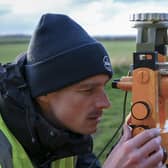 BGS scientist using a non-magnetic theodolite and fluxgate magnetometer to measure magnetic north.