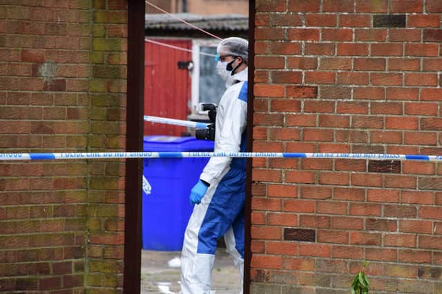 Police officers at the scene of a murder investigation in Blyth.