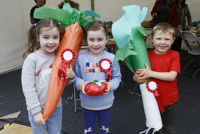 Youngsters with some giant hand-made vegetables.