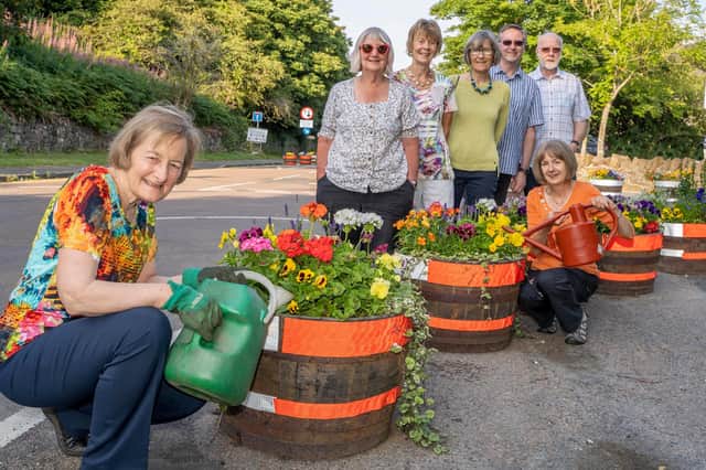 Margaret Brooks and her fellow Craster residents with their beautiful floral display. Picture: Jane Coltman
