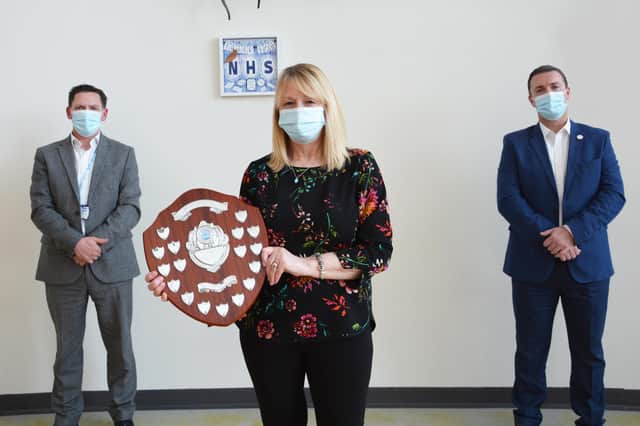 Mark Smith Business Development Manager at GV Healthcare (creators of MyPorter, right) and Damon Kent, Managing Director of NHFML - Northumbria Healthcare NHS Foundation Trust (left) present the Dennis Southern Award to Dennis' family.