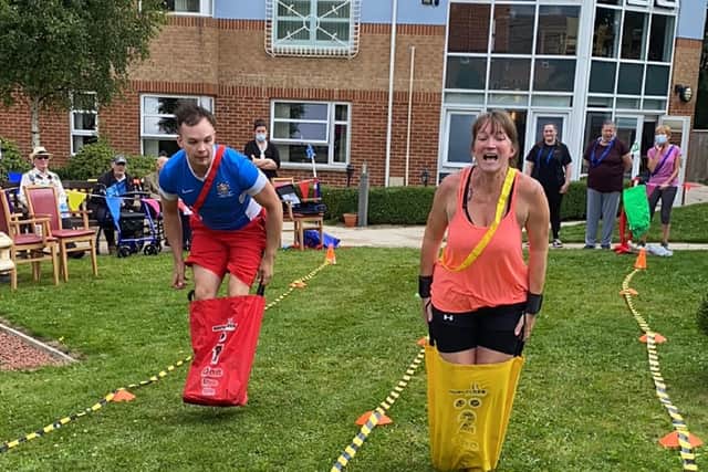 Staff members Andrew Young and Michelle Baldwin competing in a sack race at Scarbrough Court's Olympic inspired sports day.