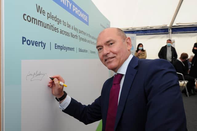 Northumbria Healthcare's chief executive Sir James Mackey signs the Our Community Promise board at the launch event in summer 2021.
