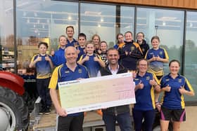 Mark Turnbull presenting a cheque to Alnwick Dolphins.