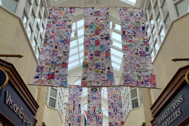 Patches created by school pupils have been combined into huge patchwork flags at Sanderson Arcade.