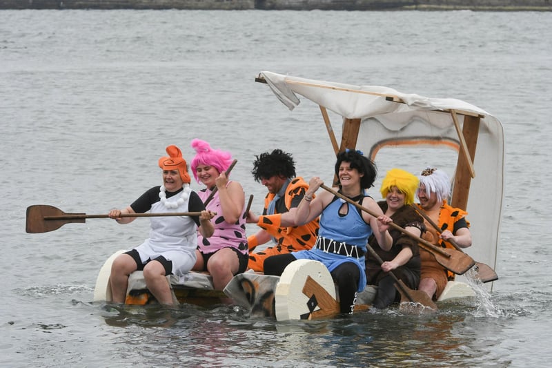 The Flintstones raft race team hard at work.