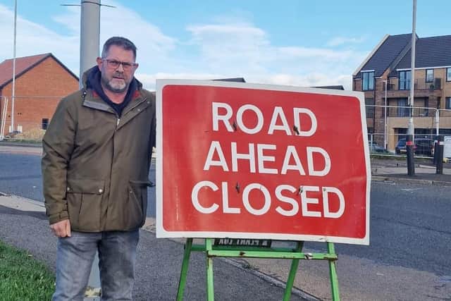 Councillor Mark Swinburn at the entrance to the closed section of the A1171.