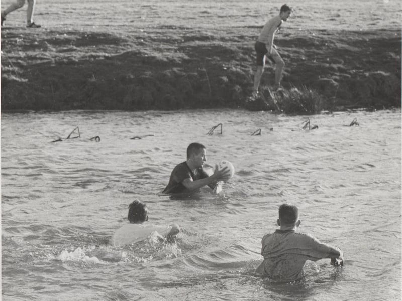 Players cross the River Aln at the conclusion of the game.
