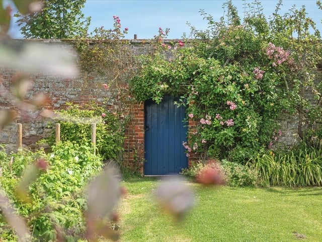 A notable feature is the enclosed walled garden, which includes fruit trees, established planting and a Grade II listed dovecote.