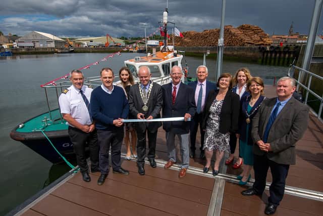 Harbourmaster Scott Ferguson, left, with Harbour Commissioners and county councillors at the naming ceremony.