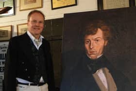 Project director Andrew Ayre with a portrait of John Mackay Wilson.