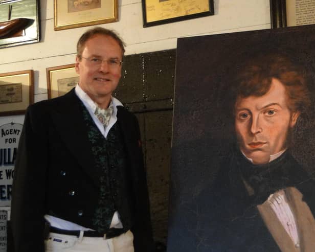Project director Andrew Ayre with a portrait of John Mackay Wilson.