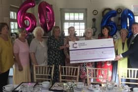 Members of the Cancer Research UK Blyth Local Committee with a cheque representing the £1 million they have raised for the charity.
