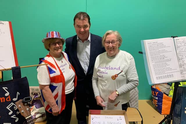 Guy Opperman MP with members of the Ponteland Ukulele Band at the fair.
