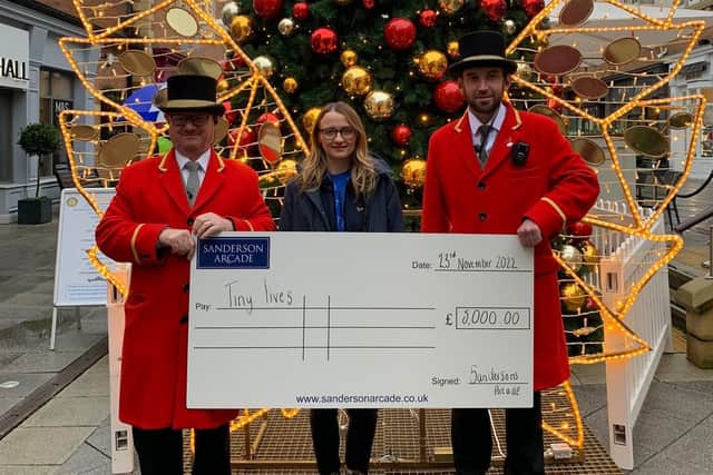 Sanderson Arcade Beadles present a cheque for £5,000 to Rachel Hardwick from Tiny Lives.