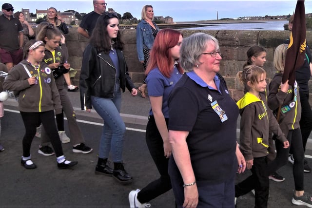 People, including children in a Brownies group, walking over the Old Bridge to Tweedmouth.