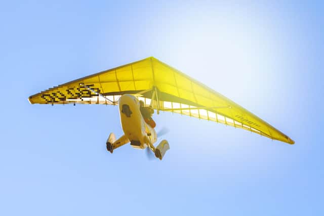 A stock image of a microlight in flight