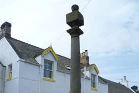 The top section of the Mercat Cross, located on land north of Crosslea in School Road, Coldingham.
