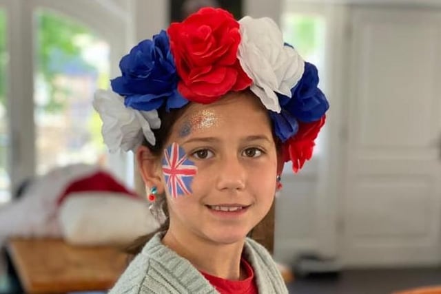 Amelie, age 8, shows off her fantastic floral headpiece.