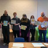 ​Members of the Sunday Art Class run by artist James Alexander Gaffney hand over the artwork to the Marie Curie ladies.
