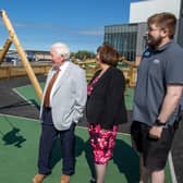 Local boy Joshua tries out one of the swings in the new play park, watched by Coun Jeff Watson, local ward county councillor Isabel Hunter and Keiron Logan, duty manager for Active Northumberland.