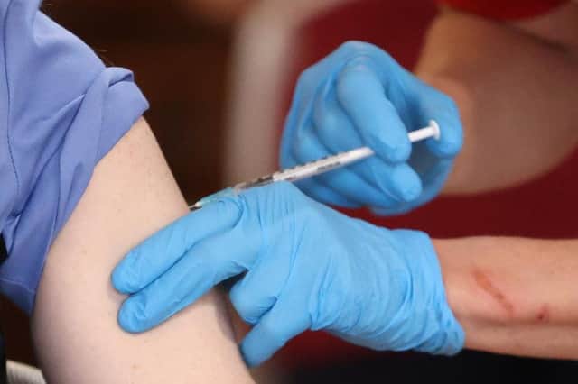 Administering a vaccine.