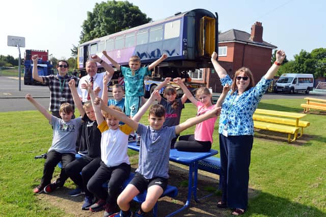 The Dales School's headteacher Dr Sue Fisher, project manager James Groundwater, Deputy Mayor John Potts and children welcome a train donated by Network Rail.
