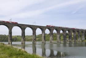 Trains cross the Royal Border Bridge at Berwick. 