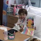 Children's Heart Unit patient Faith with her sewing magazine and new tablet bought through then charity's coronavirus fund to entertain her whilst in hospital isolation.