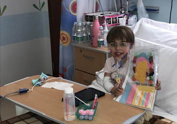 Children's Heart Unit patient Faith with her sewing magazine and new tablet bought through then charity's coronavirus fund to entertain her whilst in hospital isolation.