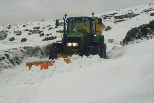 A tractor snow plough and gritter helping out near Wooler.