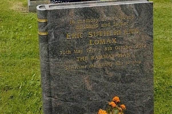Bagpiper Iris Hannah plays a tribute to the Railway Man, former army officer Eric Lomax, at his grave, in Berwick. Picture from video by Andrew Blair