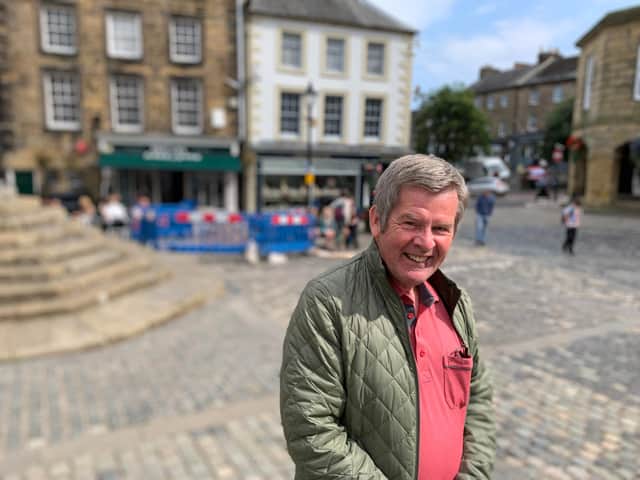 Cllr Gordon Castle in Alnwick Market Place where businesses have suffered after power cuts.