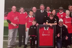 Margaret Walker, far right, and other members of the supporters' club with Bryan Robson and the special commemorative shirt. Picture: Manchester United