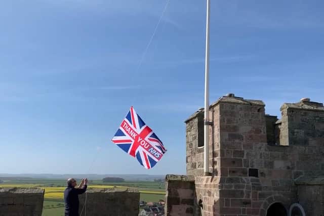 The flag is raised at Bamburgh Castle.