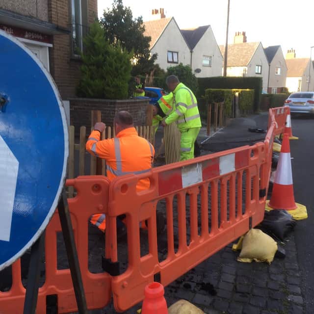Northumberland County Council workmen start to remove the fence that was blocking the footpath in Victoria Terrace, Alnwick.